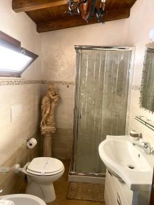 a bathroom with a shower and a toilet and a sink at Oasi Rubino in Nettuno