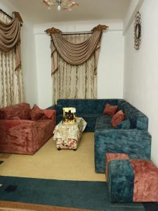 a living room with a couch and a table at Aljood apartment in Amman