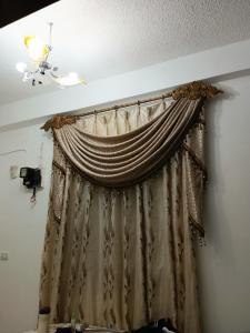a curtain in a room with a ceiling at Aljood apartment in Amman