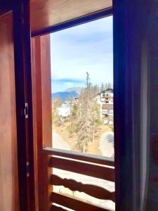 an open window with a view of a mountain at Adonis Valberg in Valberg