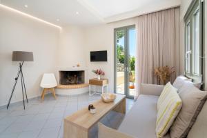 a living room with a couch and a fireplace at Blue View Villas in Stalida