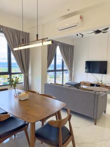 a living room with a table and a couch at Troika Kota Bharu Penthouse Homestay in Kota Bharu