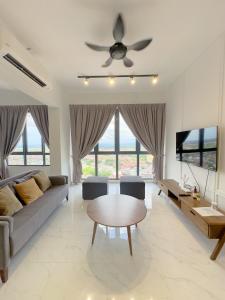 a living room with a couch and a ceiling fan at Troika Kota Bharu Penthouse Homestay in Kota Bharu