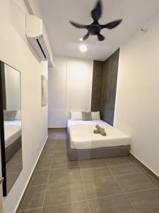a bedroom with a bed and a ceiling fan at Troika Kota Bharu Penthouse Homestay in Kota Bharu