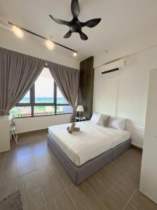 a bedroom with a bed and a ceiling fan at Troika Kota Bharu Penthouse Homestay in Kota Bharu