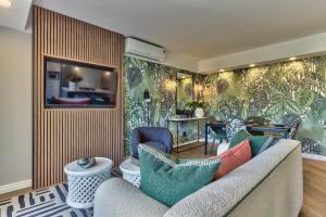 a living room with a couch and a table at 437 St Martini Gardens Apartments in Cape Town