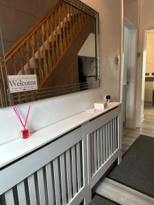 a hallway with a staircase with a large mirror at A place of Rest in Middlesbrough