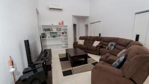 a living room with two couches and a flat screen tv at Tiramula Lodge Holiday House in Horseshoe Bay
