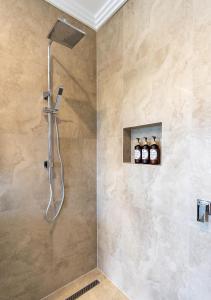 a shower with a shower head in a bathroom at Lilly Pilly Cottage Margaret River in Margaret River Town