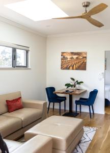 a living room with a couch and a table at Lilly Pilly Cottage Margaret River in Margaret River Town