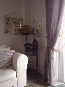 a living room with a couch and a table and a window at Calma in Perdika