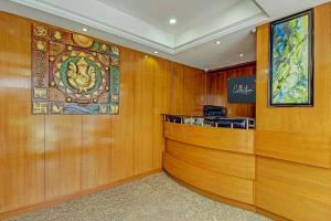 a salon with wooden walls and a stained glass window at Capital O Sri Krishna Suites Near 7d Voyage in Bangalore