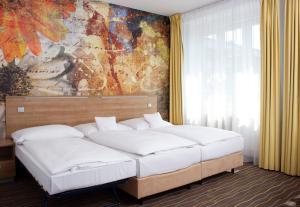 Postel nebo postele na pokoji v ubytování Akcent hotel