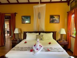 a bedroom with a large bed with flowers on it at La Digue Holiday Villa in La Digue