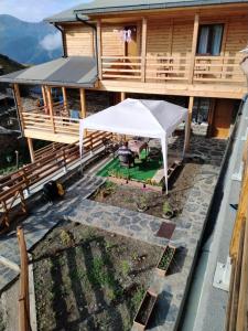 an aerial view of a house with a white tent on a patio at HOTEL AMIRAN in Tusheti