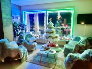 a room with chairs and a christmas tree in it at Adonis Valberg in Valberg