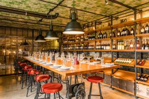 a long table in a restaurant with red stools at Landgut am Pößnitzberg in Leutschach