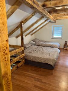 two bunk beds in a room with wooden ceilings at Kuca za odmor Dejo in Krupa na Vrbasu