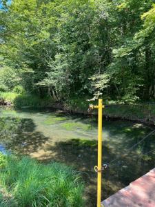 a yellow pole with a rope in a river at Kuca za odmor Dejo in Krupa na Vrbasu