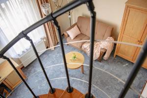 a living room with a couch and a table at Villa Sedan - Destigo Hotels in Sopot