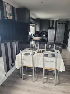 a kitchen with a table and two chairs and a kitchen with at Sanity Sanctuary in Leysdown-on-Sea