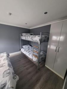 a room with two bunk beds and a closet at Sanity Sanctuary in Leysdown-on-Sea
