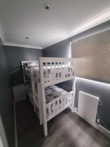 a room with two bunk beds in a room at Sanity Sanctuary in Leysdown-on-Sea