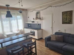 a living room with a table and a couch at Cosy 2 room apartment with nice vibe, for up to 4 in Ljubljana