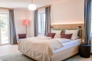 a bedroom with a large bed in a room at Landgut am Pößnitzberg in Leutschach