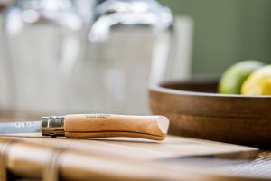 a knife sitting on top of a wooden cutting board at Landgut am Pößnitzberg in Leutschach