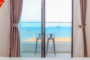 a room with a table and a chair in front of a window at STAR APARTMENT- BEACH FRONT in Quy Nhon
