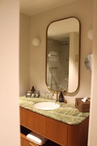 a bathroom with a sink and a large mirror at Landgut am Pößnitzberg in Leutschach