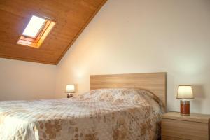 a bedroom with a bed and two night stands at Casa da Carreira de Loriga in Loriga