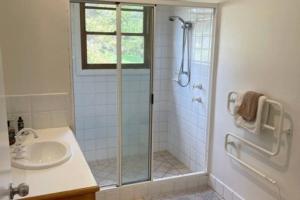 a bathroom with a shower and a sink at Pine View Cottage - Margaret River in Cowaramup