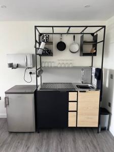 a small kitchen with a sink and a refrigerator at Studio apartment in Harefield in Harefield
