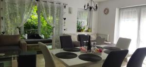 a living room with a table and chairs and a couch at Rekreační wellness dům Mariposa in Lipoltice