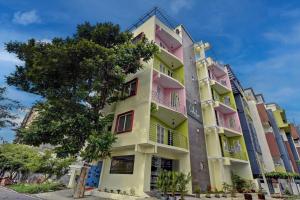 a building with pink and yellow at Collection O 73565 J J Global Exotics Stays in Bangalore