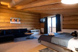 a bedroom with a bed and a couch in a room at Шале PARADISE in Mizhhirʼʼya