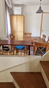 a dining room with a wooden table and chairs at Plage des Sablettes -St Mandrier Maison du Pécheur in La Seyne-sur-Mer