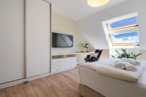 Televízia a/alebo spoločenská miestnosť v ubytovaní Apartament 24 AbsyntApart Rynek Wrocław