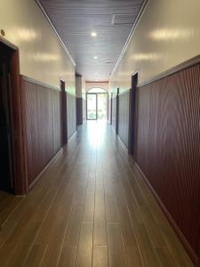 an empty hallway of an office building with wood paneling at Phụng Kim Thảo Hotel Long An in Long An