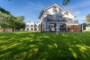 an image of a house with a large yard at Lodge54 in Sankt Peter-Ording +14 photos