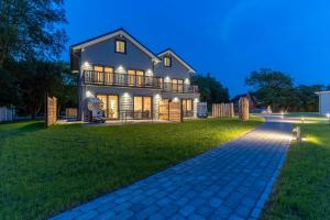 a large house with a walkway in front of it at Lodge54 in Sankt Peter-Ording