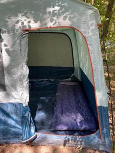 a tent with the door open and a mattress inside at Stoke Travel's Amsterdam Camping in Amsterdam