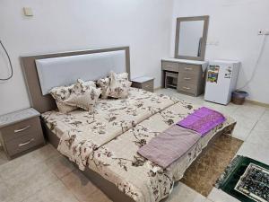 a bedroom with a large bed and a mirror at شقة مفروشة في المدينة المنورة- رانونا1 in ‘Urwah
