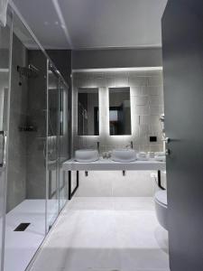 a bathroom with two sinks and a shower at Hotel Leonessa in Brescia