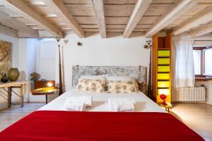 een slaapkamer met een groot bed en een rode deken bij Palazzo Lavagnoli in Verona