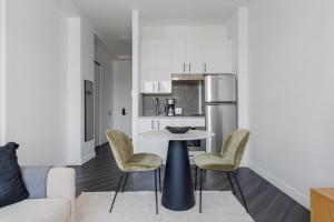 a kitchen with a table and chairs in a room at East Village 1br w balcony garden gym nr bars NYC-1211 in New York