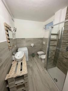 a bathroom with a sink and a toilet and a shower at Holiday House in Ancona