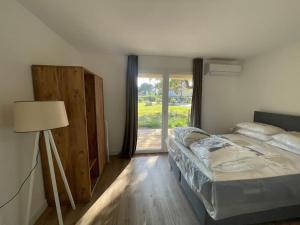 Un dormitorio con una cama y una lámpara y una ventana. en T4 neuf Porto Vecchio Calarossa, en Lecci 32 fotos más